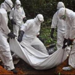 Health workers bury the body of a woman who is suspected of having died of the Ebola virus in Bomi county, Monrovia, Liberia